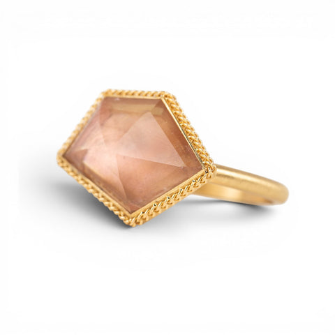 Gold ring with an Oregon sunstone hexagonal stone on a white