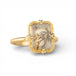 Gold ring with a rectangular dendritic quartz stone on a white background