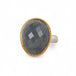 Ring with gray quartz stone, gold bezel and silver band on a white background