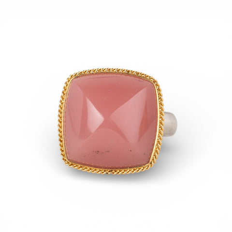 Gold and silver ring with pink guava quartz stone on a white background