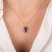 Indigo tanzanite teardrop-shaped gemstone pendant on a person