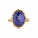 Gold ring with a large tanzanite gemstone on a white background