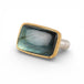 Gold and silver ring with a rectangular labradorite stone on a white background