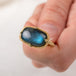 Close up of a gold ring with a labradorite gemstone