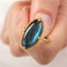 Close up of a gold ring with a labradorite stone