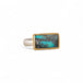 Turquoise ring with gold bezel and sterling silver band on white background