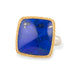 Ring with lapis stone, gold setting and silver band on a white background