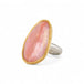 Handcrafted ring with rhodochrosite stone, gold setting and silver band on a white background