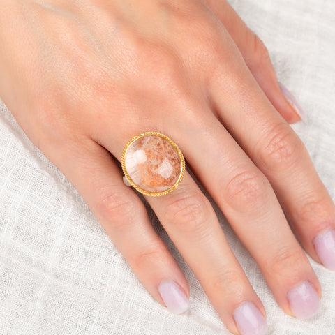 Ring with gold bezel, silver band and lodolite stone on a hand