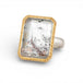 Ring with gold bezel, silver band and lodolite quartz stone on a white background