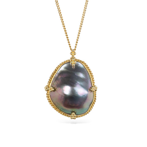 Mabe pearl pendant necklace with gold setting on a white background