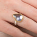 Mabe Pearl ring with gold bezel and silver band on a person's finger