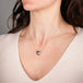 Necklace with a mabe pearl pendant on a person's neck