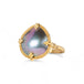 Gold ring with a mabe pearl on a white background