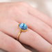 Gold ring with a moonstone gemstone on a hand