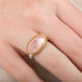 Ring with morganite stone, gold bezel and silver band on a person's finger