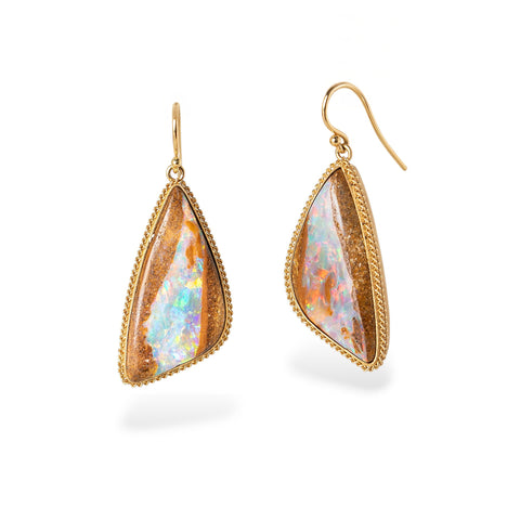 Gold-framed teardrop earrings with opalized wood stones on a white background