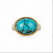 Turquoise ring with gold bezel and sterling silver band on white background