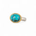Turquoise ring with gold bezel and sterling silver band on white background
