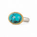 Turquoise ring with gold bezel and sterling silver band on white background
