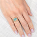 Gold ring with an aquamarine gemstone on a hand