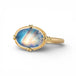 Gold ring with a moonstone on a white background