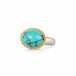 Turquoise ring with gold bezel and sterling silver band on white background