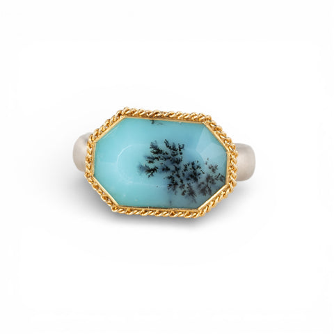 Gold and silver ring with peruvian opal stone on a white background