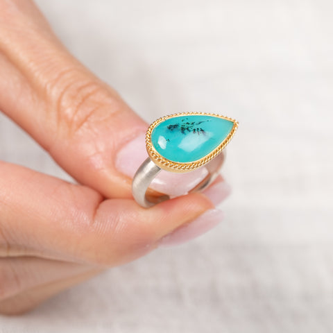 Handmade ring with peruvian opal stone held in hand