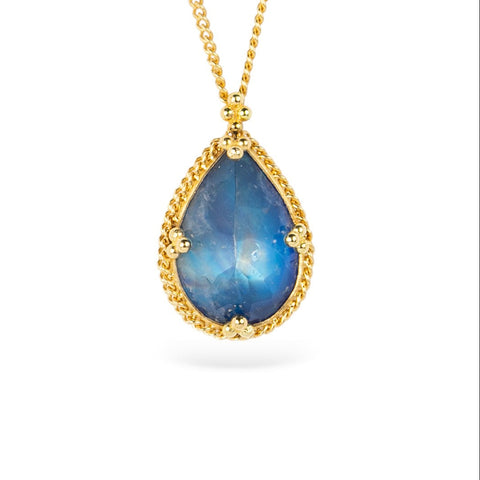 Gold necklace with a moonstone teardrop pendant on a white background