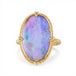Gold ring with a boulder opal stone on a white background