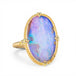 Gold ring with a boulder opal stone on a white background