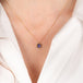 Gold necklace with a tanzanite pendant on a person