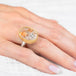 Gold and silver ring with a quartz with pyrite stone on a hand against a white background