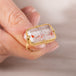 Gold ring with a Super 7 stone on a blurred background