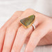 Close up of hand wearing a rainbow pyrite druzy ring with gold bezel and silver band