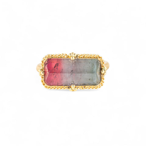 Handcrafted gold ring with a watermelon tourmaline gemstone and gold band on a white background