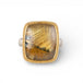 Gold and silver ring with a rutilated quartz stone on a white background