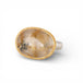 Ring with a gold bezel, silver band and rutilated quartz stone on a white background