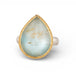 Teardrop-shaped gold and silver ring with rutilated topaz stone on a white background