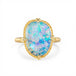 Ring with a boulder opal stone and gold band on a white background