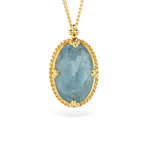 Gold necklace with an oval aquamarine gemstone pendant on a white background