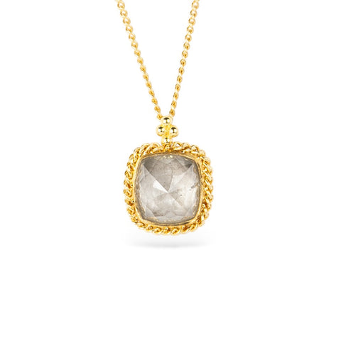 Gold necklace with a diamond pendant on a white background