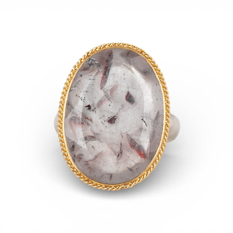 Gold and silver ring with a super 7 stone on a white background