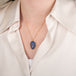 Handcrafted gold necklace featuring a leaf-shaped tanzanite on a person