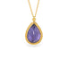 Gold necklace with a tanzanite teardrop pendant on a white background