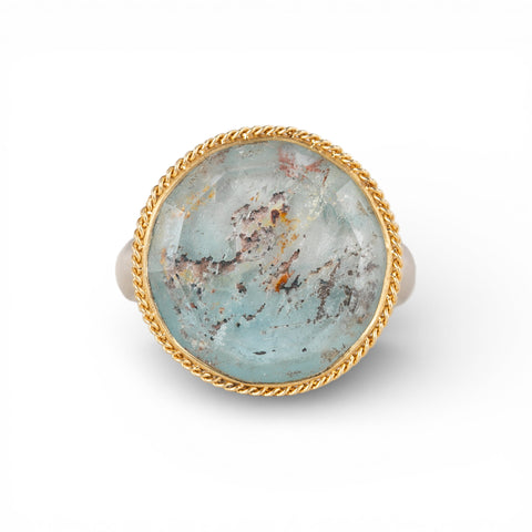 Silver and gold ring with topaz stone on a white background