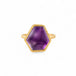 Gold ring with an amethyst gemstone on a white background