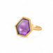 Gold ring with an amethyst gemstone on a white background