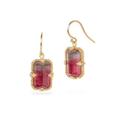 Gold earrings with tourmaline gemstones on a white background